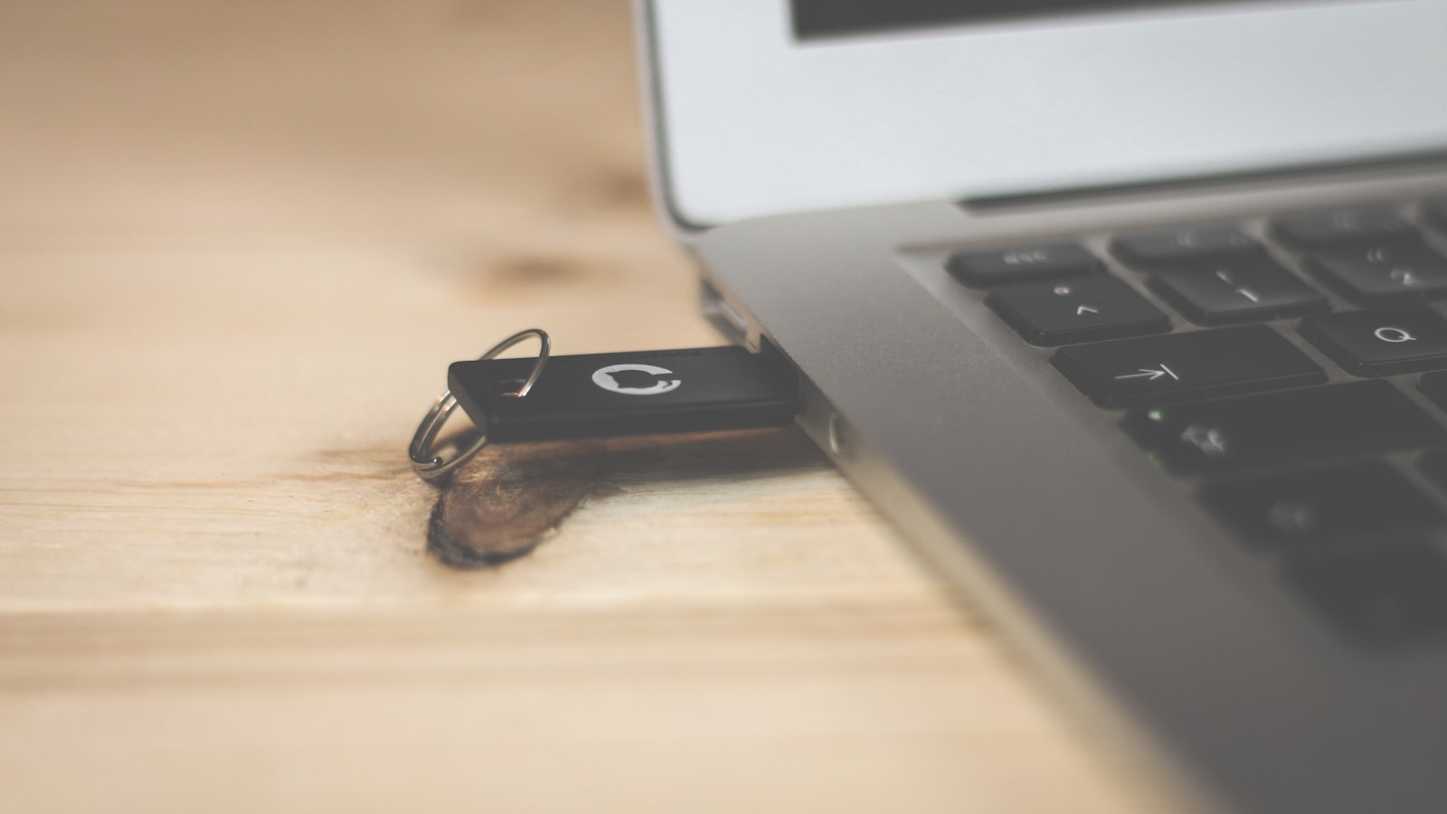 USB wireless dongle receiver plugged into gaming PC port close-up